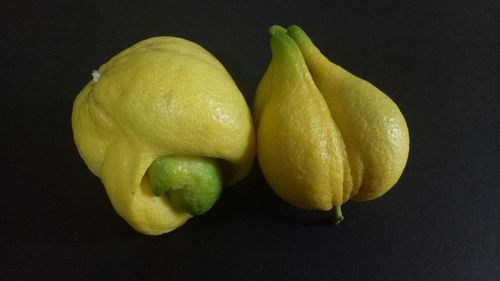 Close-up of fruits on table against black background