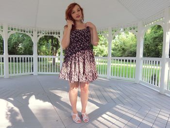 Full length of young woman standing outdoors