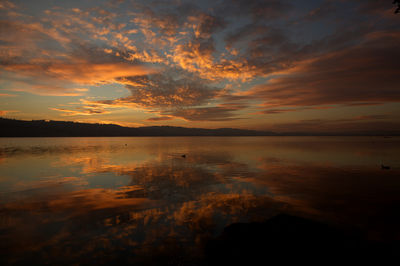 Scenic view of sea against orange sky