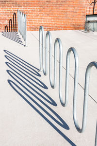 Urban bike rack - wavy shaped tubular metal with strong contrasting shadow