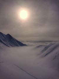 Scenic view of snowcapped mountains against sky during sunset