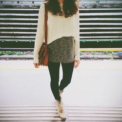 Full length of woman standing by railing