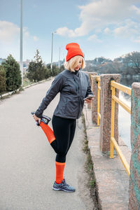 Full length of woman standing against sky