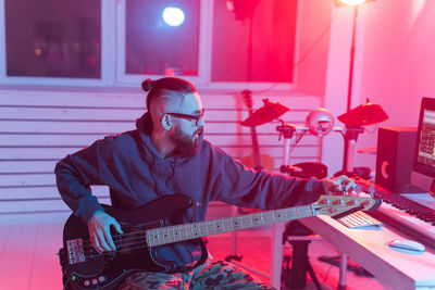 Young man playing guitar at music concert