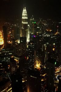 Aerial view of city lit up at night