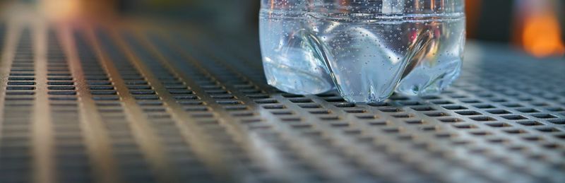 Panoramic view of water bottle on metallic table