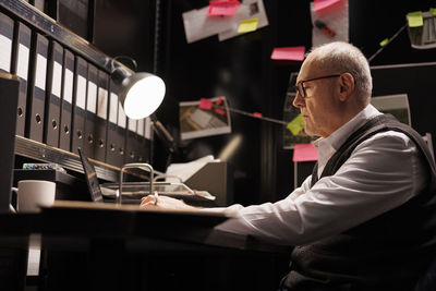 Side view of man working at office