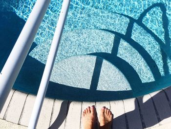 Low section of woman standing on tiled floor