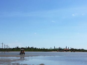 Tranquil view of beach against blue sky