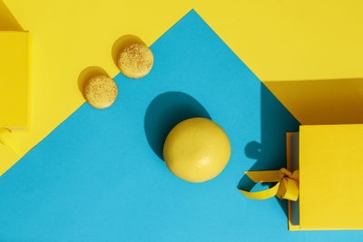 Directly above shot of orange and dessert on blue paper