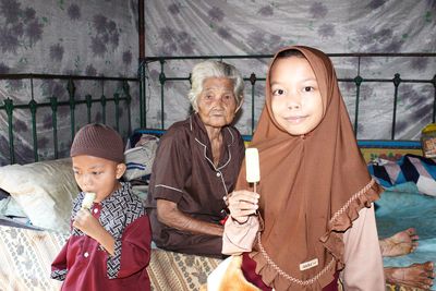 Portrait of smiling mother and daughter at home