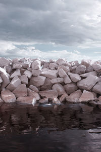 Rocks in sea against sky