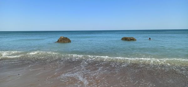 Scenic view of sea against clear blue sky