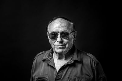 Portrait of mid adult man against black background