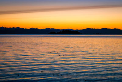 Scenic view of lake against sky during sunset