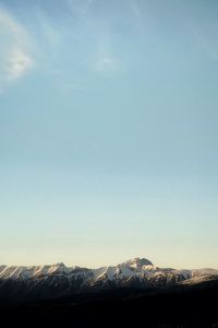 Scenic view of snowcapped mountains against clear sky