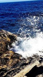 Waves on beach against sky