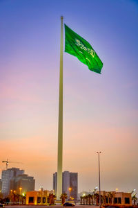 Low angle view of flag against sky at sunset