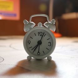 Close-up of alarm clock on table