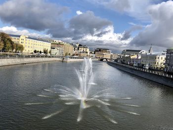 Panoramic view of fountain in city against sky