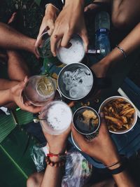 Midsection of people holding drink