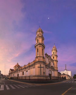 View of illuminated building against sky at sunset