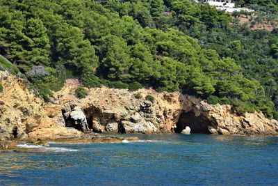 Scenic view of sea against rock formation