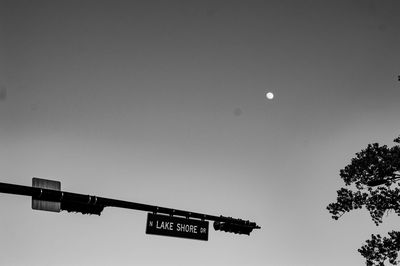 Low angle view of sign against clear sky