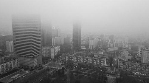 High angle view of buildings in city during foggy weather