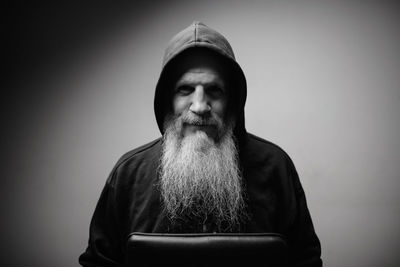 Portrait of man wearing hat against gray background