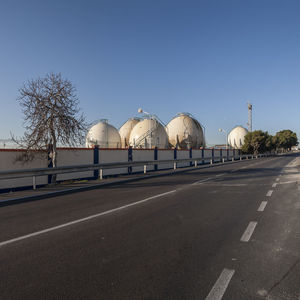 Road by city against clear sky