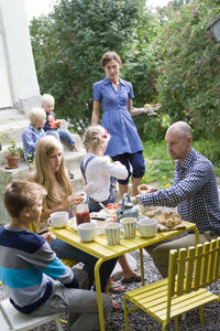 Family having lunch in back yard