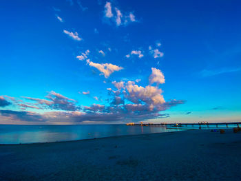 Scenic view of beach against blue sky