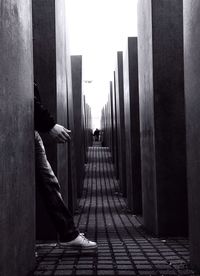 Woman walking on paving stone wall