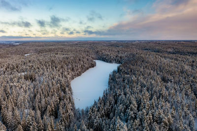 People walking on frozen lake halkolampi from drone perspective, luukki espoo, vihti, finland