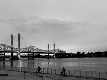 Bridge over river with city in background
