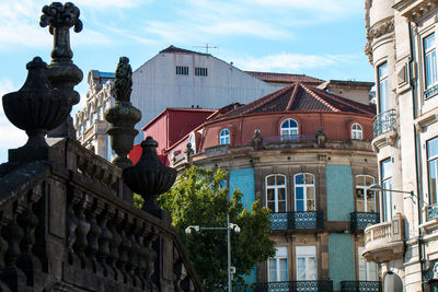 Low angle view of statue against building in city