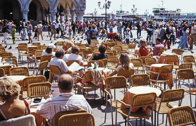 Rear view of people relaxing in city