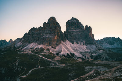 Rock formations on landscape against clear sky