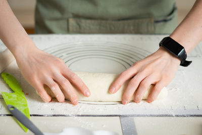 Cropped hands of man making clay