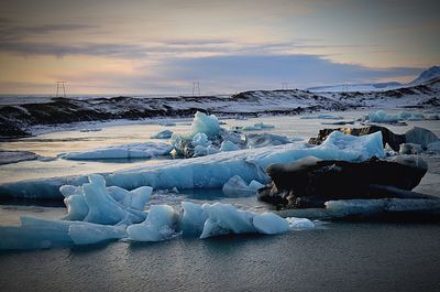 Frozen lake against sky during winter