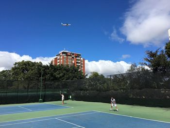 Airplane flying against cloudy sky