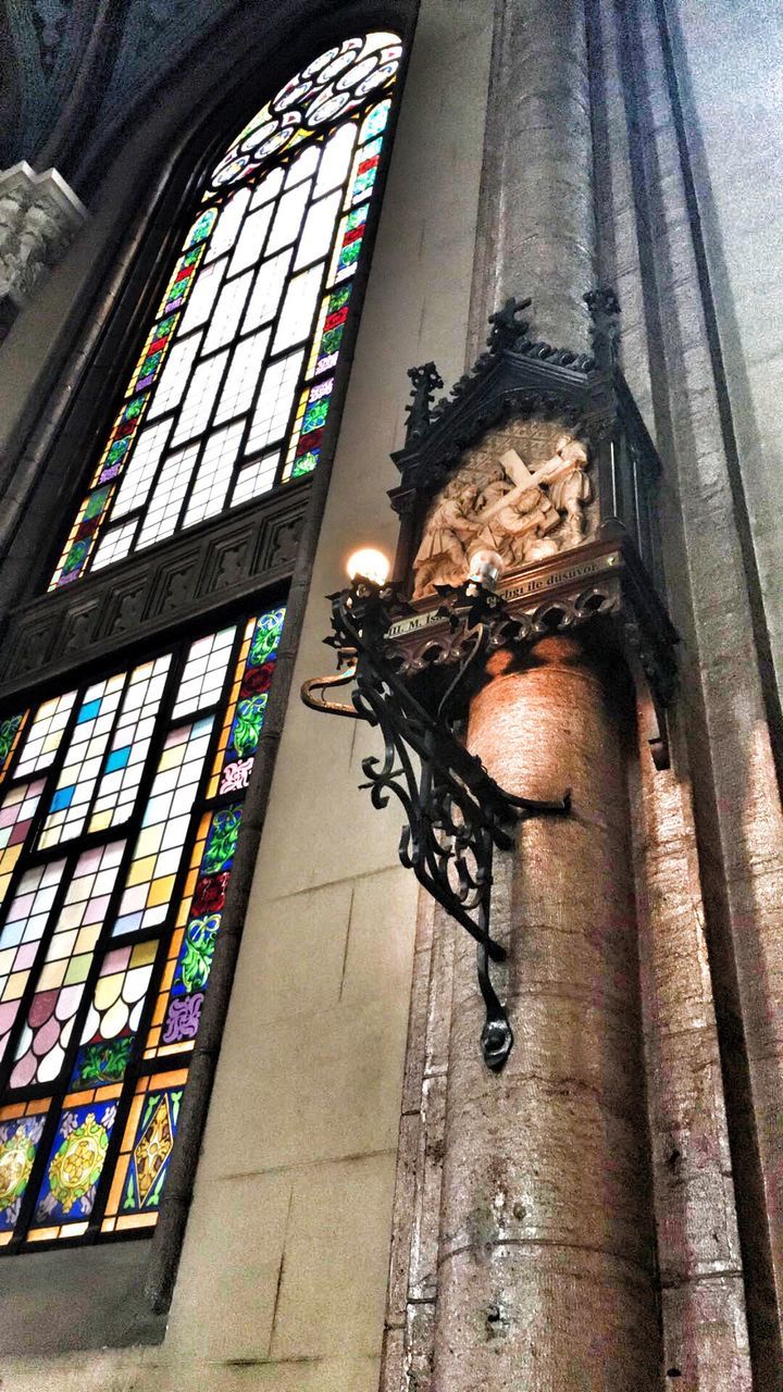 indoors, low angle view, ceiling, religion, spirituality, place of worship, architecture, built structure, window, church, architectural feature, arch, famous place, multi colored, history, no people, architectural column