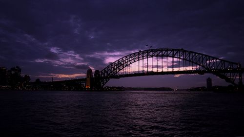 View of bridge over sea against cloudy sky