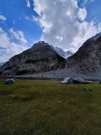 Scenic view of land and mountains against sky