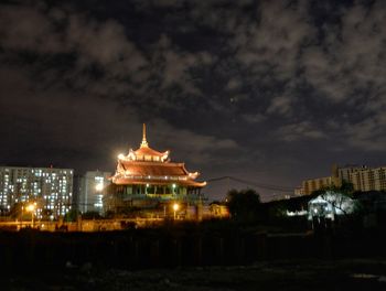 Illuminated building against sky at night