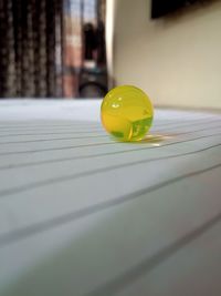 Close-up of yellow ball on table