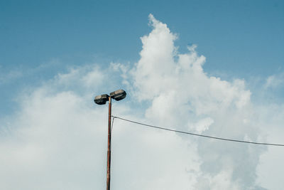 Low angle view of street lights against sky