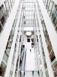 High angle view of people walking on staircase in shopping mall