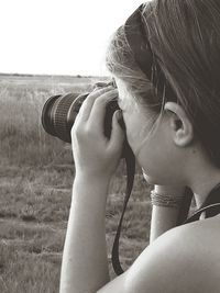 Close-up of a smiling young woman against clear sky